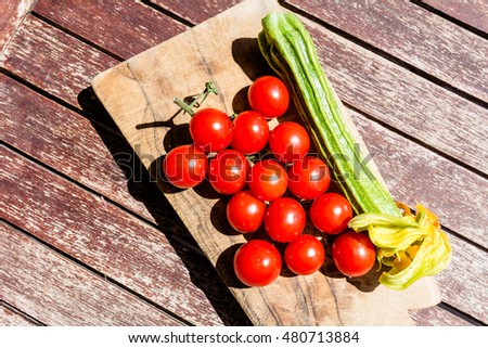 Tomatoes and zucchini on a cutting board with top view
