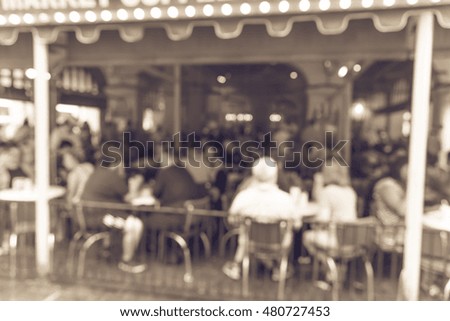 Blurred abstract a French cafe shop and restaurant in New Orleans, Louisiana, US. Crowd of people enjoy coffee & beignets for breakfast. New Orleans deeply tied to French food culture. Vintage filter.