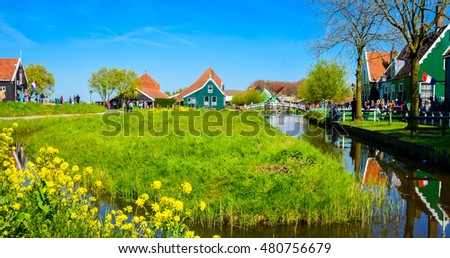 Traditional dutch windmills and houses near the canal in Zaanse Schans, Netherlands, Europe