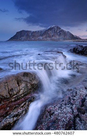 The rocky beach of Skagsanden on the Lofoten in northern Norway, photographed at dawn in winter.