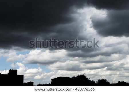 Black cloudy on the sky with raining above the city
