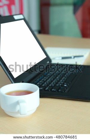 Laptop with Blank screen on desk in conference room. 