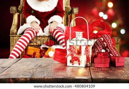 xmas wooden old table place and free space for your decoration with background of woman legs and xmas tree 