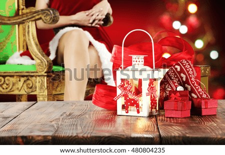xmas wooden old table place and free space for your decoration with background of woman legs and xmas tree 