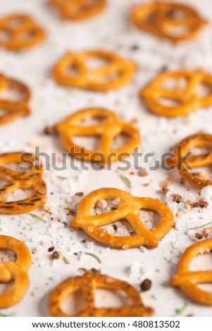 Salted pretzels on white wood background