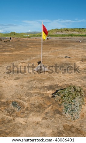 photo of safety beach swim flag on a sandy beach ireland