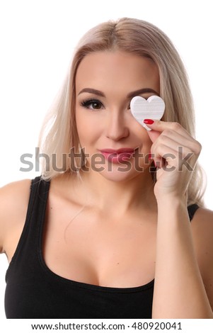 Woman with heart symbol on her eye. Close up. White background