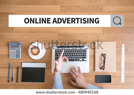 ONLINE ADVERTISING Businessman working with financial reports and a laptop with other objects around, coffee,  top view