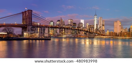 Panorama of Brooklyn Bridge and Manhattan skyscrapers at sunrise time, beautiful  gentle colors of sky and city illuminations, New York, USA - Big size