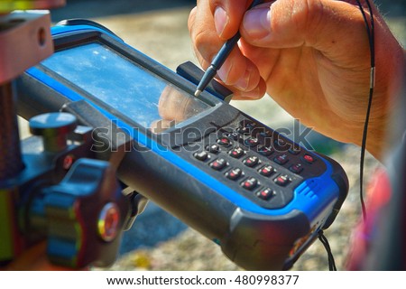 Field controller on smart pole for surveying. GPS surveying instrument.  Royalty-Free Stock Photo #480998377