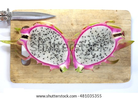 Dragon fruit on wooden chopping board, Adjustment Select focus for background.