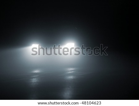 headlights of a car approaching in the dark Royalty-Free Stock Photo #48104623