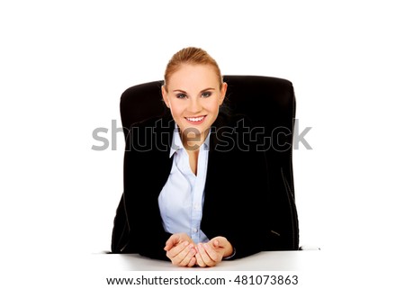 Happy business woman sitting behind the desk