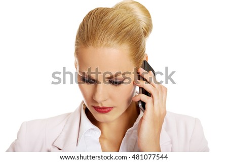 Serious business woman talking through a mobile phone