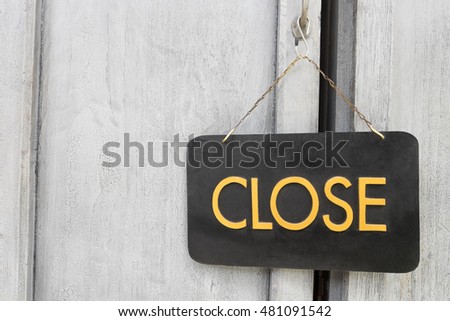 Close sign on old wood door.