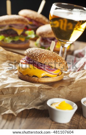 Fast food,burger and beer on a wooden panel , selective focus