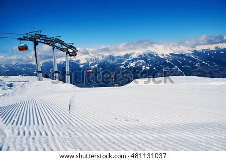 Prepared snowcat track at alpine skiing resort on a sunny day