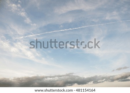 Beautiful blue cloudy sky with jet trail