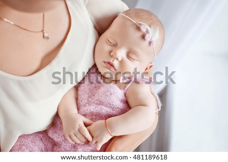 Loving baby sleeping in mother's hands.  Closeup picture
