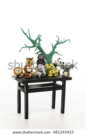 Group of animals with green tree on the black table