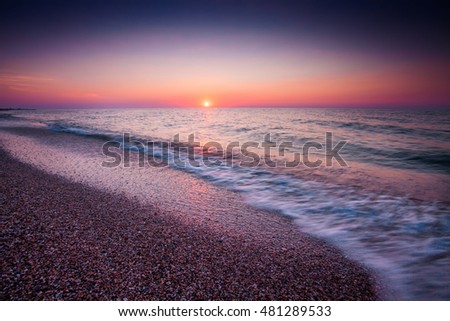 Waves motion during golden hour sunrise over the sea. Image contain soft focus and blur
