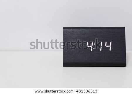 Black digital clock on a white background showing time 4:14 (four hours fourteen minutes)