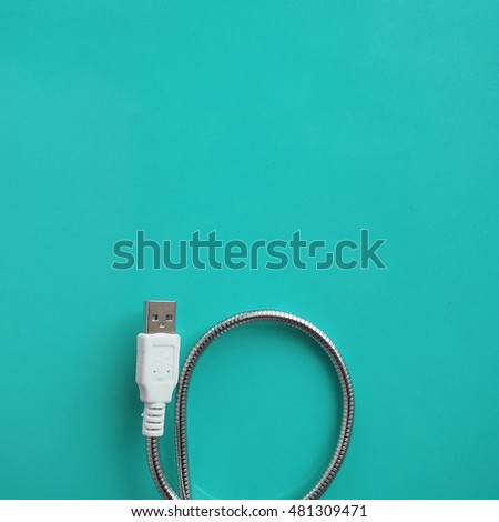 USB Cable Plug on mint green background. Flat Lay. Minimalism style.