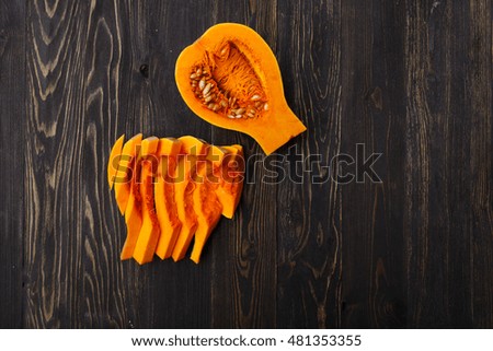 pumpkin slices on a black wooden background