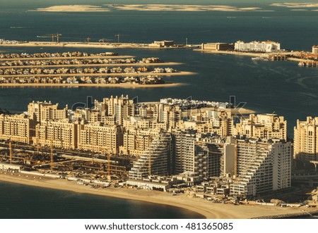 Scenic panoramic skyline: luxury hotels under construction on Palm Jumeirah in Dubai, UAE. Aerial view. Travel background.