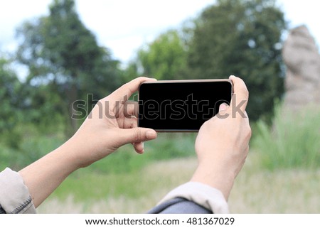 Close up of woman using mobile smart phone outdoor