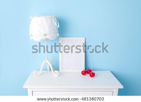Blue Room. white dresser. poster frame. 