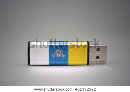 usb flash drive with the national flag of canary islands on gray background. concept