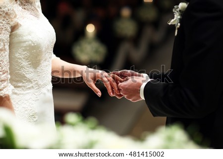 put a wedding ring to bride on wedding Royalty-Free Stock Photo #481415002