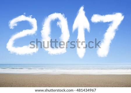 2017 arrow up sign shape white clouds in the sky on sea beach background