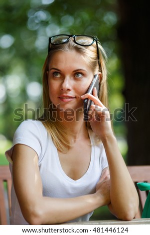 Student talking on phone while sitting at table