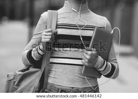 Girl with backpack and tablet in hands,black -white photo
