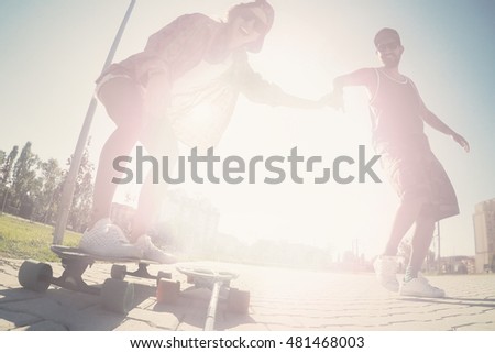 Young happy people Longboarding, skateboarding, sport in a city park