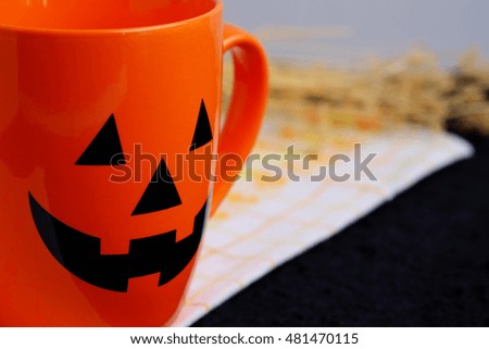 Halloween cup on black background. Halloween festival concept, close up, decorated, selective focus.