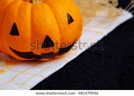 Halloween pumpkin on black background. Halloween festival concept, close up, decorated and selective focus.