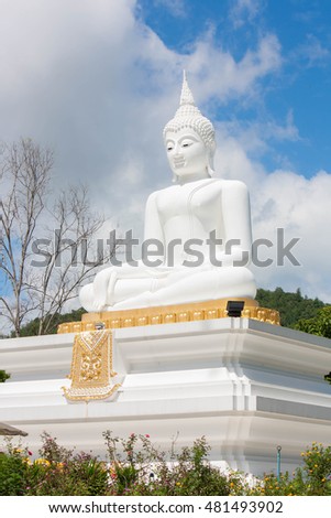 Big buddha statue on blue sky background.