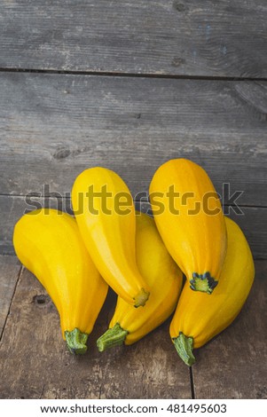 Yellow zucchini on a wooden background