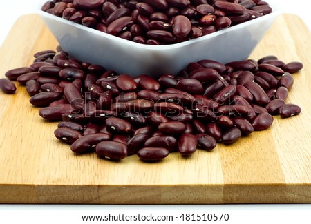 Red bean in white plastic bowl and wooden table. Ingredient bean on white background