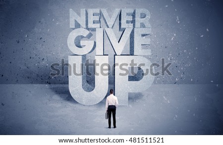 A stressed out business worker standing in front of huge block letters saying never give up in blue open environment concept