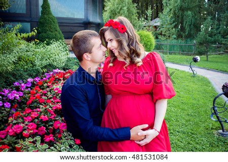 pregnant woman with her husband outdoors