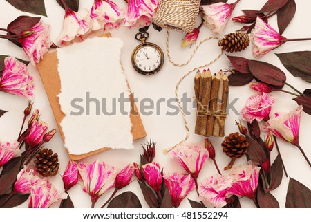 Top view of beautiful flowers and sketchbook on white background. Copy space