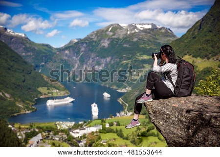 Geiranger fjord, Beautiful Nature Norway panorama. Nature photographer tourist with camera shoots.