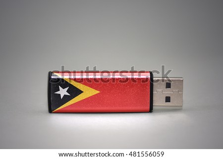 usb flash drive with the national flag of east timor on gray background. concept
