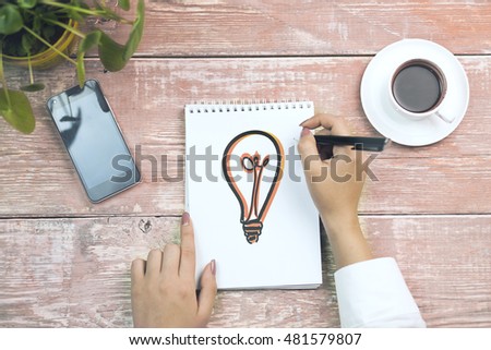 Woman painting bulb, education, objects and technology concept