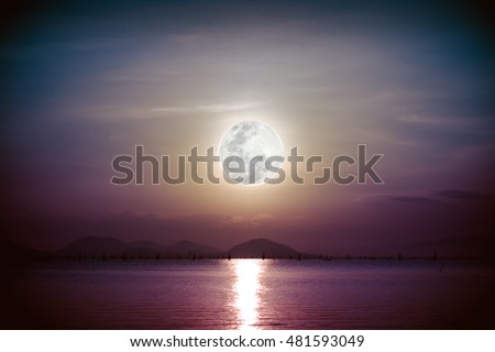 Fantastic view of the sea. Romantic scenic with full moon on sea to night. Reflection of moon in water. Vignette picture style. The moon were NOT furnished by NASA.
