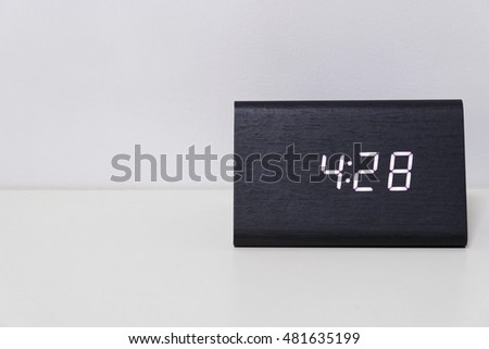 Black digital clock on a white background showing time 4:28 (four hours twenty-eight minutes)